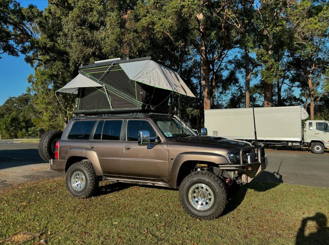 SUV with deluxe rooftop tent setup in a scenic outdoor area, showcasing Australia's most affordable spacious rooftop tent.